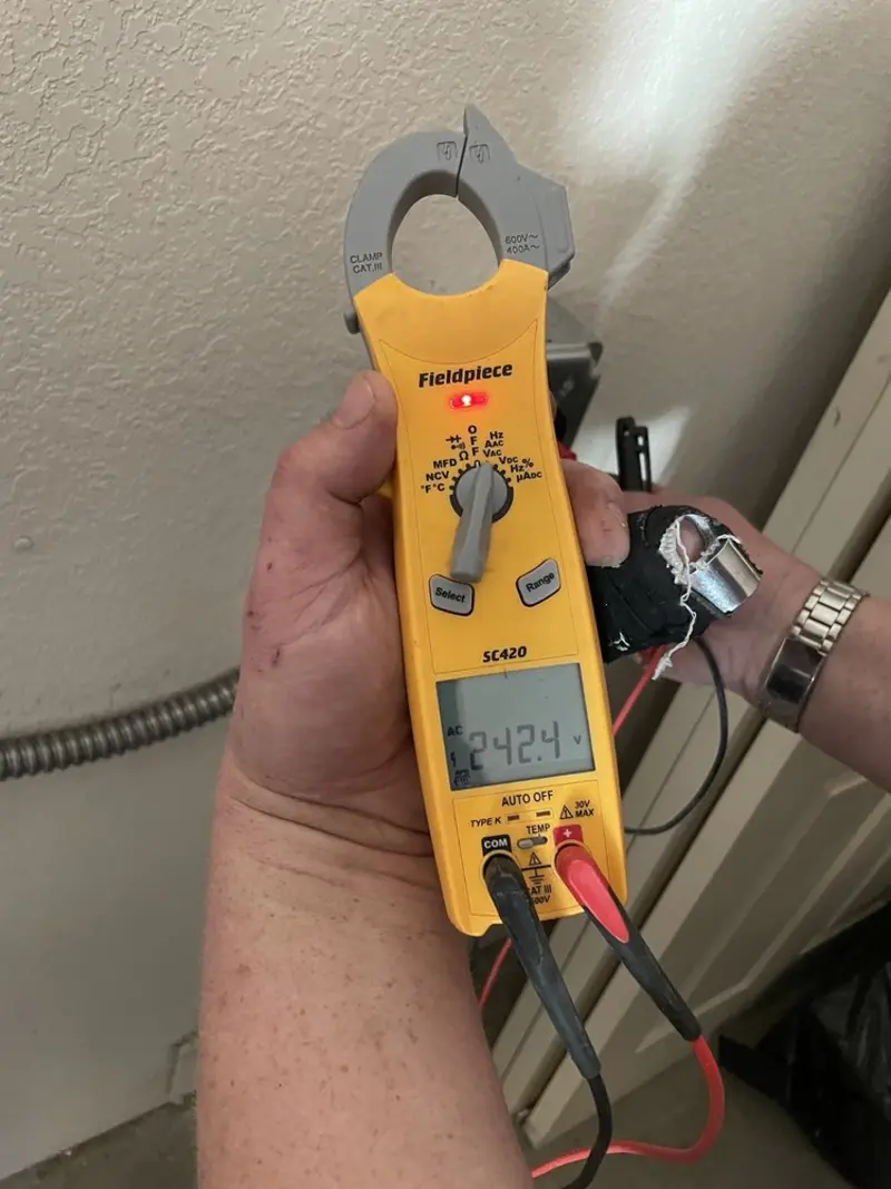 Voltage testing with clamp meter during Whole House Surge Protector in Auburn